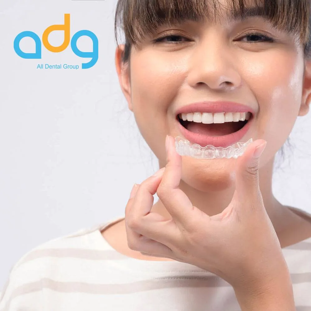 Patient holding a clear Invisalign aligner